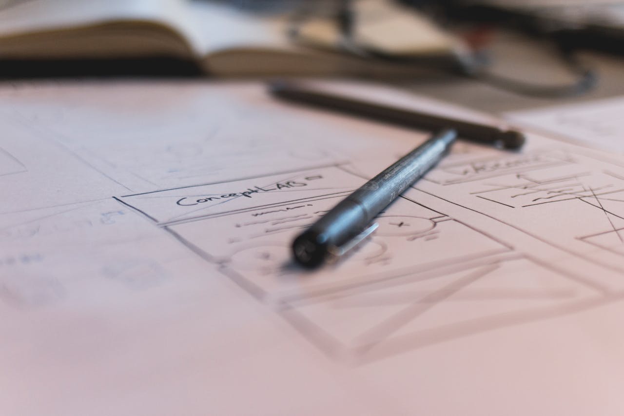 A sketch with notes and a pen on paper. Ideal for planning or design concepts.